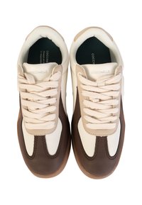 Sneakers z brązowym skórzanym noskiem, białymi skórzanymi bokami, beżowymi akcentami i jasnobeżowymi sznurowadłami. Płaska gumowa podeszwa. Minimalne oznakowanie marki.