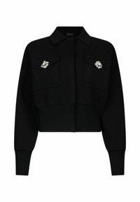 Maglione nero corto con colletto, con due tasche sul petto e spille decorative sulle tasche, realizzato in tessuto strutturato.