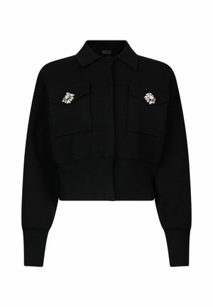 Maglione nero corto con colletto, con due tasche sul petto e spille decorative sulle tasche, realizzato in tessuto strutturato.