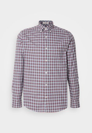 Camisa de botones con un patrón de cuadros en colores rojo, azul y blanco. Fabricada en algodón, tiene mangas largas y un dobladillo redondeado.