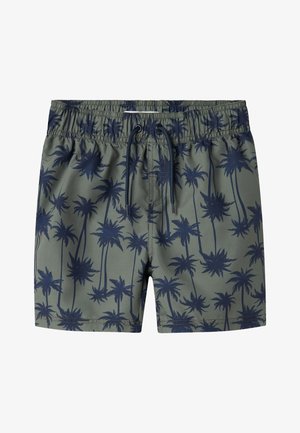 Groene zwembroek met een marineblauw palmbomenpatroon, elastische tailleband met trekkoord en een gladde, lichte textuur.