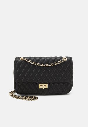 Black quilted leather handbag with gold chain strap and rectangular gold clasp on front flap.