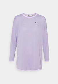 Lavender long-sleeve top featuring a round neckline, side slits, and a small black logo accent. Soft, lightweight fabric with subtle texture.
