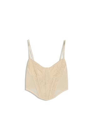 Crop top style corset en dentelle beige avec fines bretelles réglables et motifs floraux complexes sur le panneau avant.