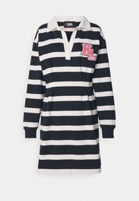 Randig klänning i marinblått och vitt, med polo-krage, långa ärmar och ett rosa "KL" logopatch på bröstet.