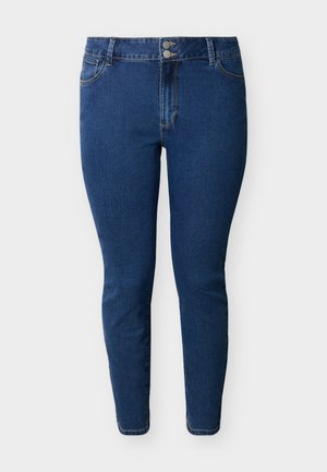 Μπλε στενά τζιν ψηλόμεσα με δύο μπροστινά κουμπιά, μπροστινές τσέπες και θηλιές για ζώνη, εμφανιζόμενα σε απλό ανοιχτό φόντο.