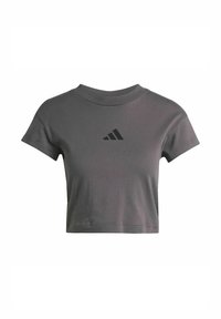 Grijze cropped t-shirt van katoen, met een ronde halslijn en korte mouwen. Het heeft een zwart Adidas-logo aan de voorkant.