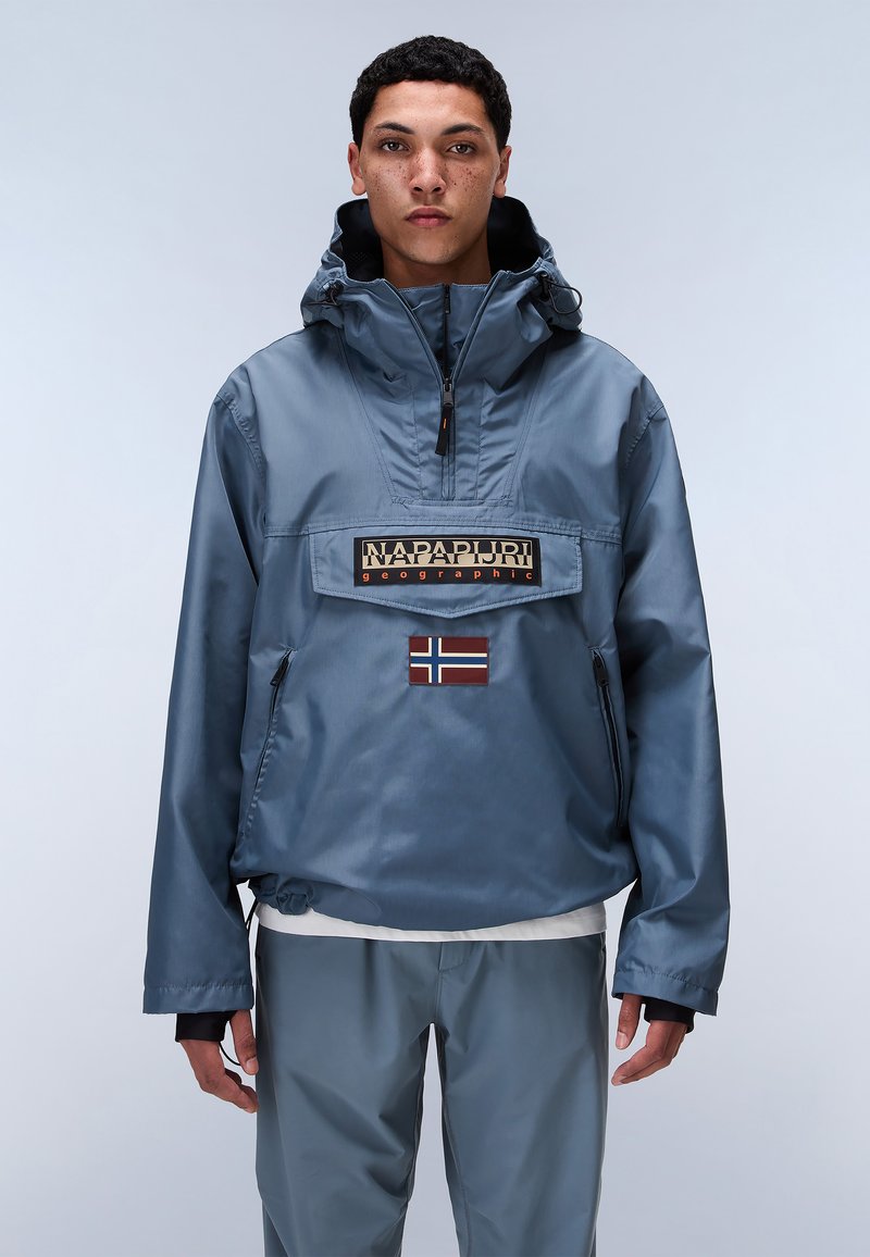 Blue, wind-resistant jacket with a quarter zip, adjustable hood, and "Napapijri" logo. Features a Norwegian flag patch and side pocket.