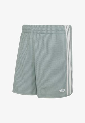 Světlounce zelené sportovní šortky s elastickým pasem, bílými třemi pruhy po stranách a malým logem Adidas na levé noze.