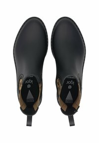 Stivali impermeabili in gomma nera con una texture liscia, punta arrotondata, design slip-on e accenti marrone chiaro contrastanti sulla fodera interna.