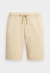 Beiga bomullsshorts med elastisk midja och dragsko. Har en mjuk textur och rak passform, som slutar strax ovanför knäet.