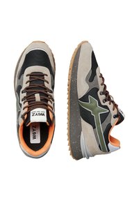 Un paio di sneakers sportive con suede beige, rete nera, dettaglio a stella verde, lacci marroni, interni arancioni e suole in gomma testurizzata, mostrati dall'alto e di lato.