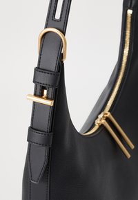 DKNY MINDY złoty