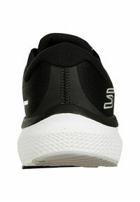 Chaussure de sport noire avec une tige texturée, une semelle sculptée blanche et un col rembourré. Présente un marquage minimal au niveau du talon.