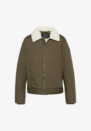Kurtka typu bomber w oliwkowej zieleni z białym kołnierzem z baranka, przednim zamkiem błyskawicznym, dwoma bocznymi kieszeniami oraz ściągaczem na dole. Wytrzymały materiał z lekkim ociepleniem.