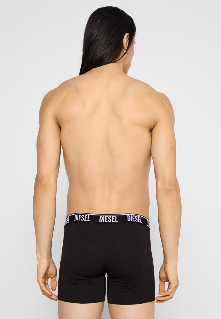 Black boxer briefs with a black waistband displaying "DIESEL" in white. Material appears smooth with a snug fit. No additional patterns or details.