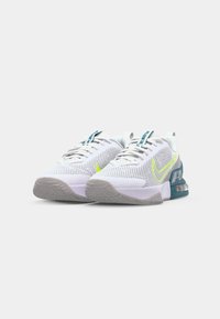 White mesh athletic shoes with a textured surface, green accents, and a blue heel piece. Features gray rubber outsole and lace-up design.