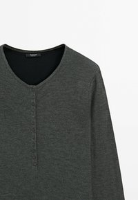 Dark gray long-sleeve henley shirt featuring a V-neck, textured fabric, and a button-front placket with five buttons.