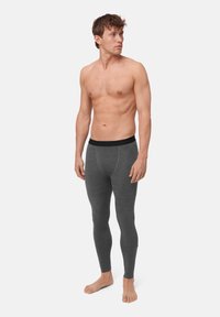 Szare legginsy termiczne wykonane z miękkiego materiału, z czarnym elastycznym paskiem w talii i dopasowanym krojem od pasa do kostek.