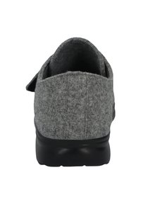 Gray felt slipper with a cushioned black sole. Features a rounded back and a soft texture, designed for comfort and warmth.