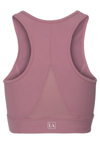 Sport bra in muted pink fabric, featuring a mesh back panel, wide straps, and a logo accent at the bottom hem. Smooth, stretchy texture.