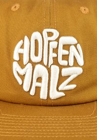 Brown cap featuring white embroidered text that reads "HOPFEN MALZ," with a textured fabric and a curved bill.