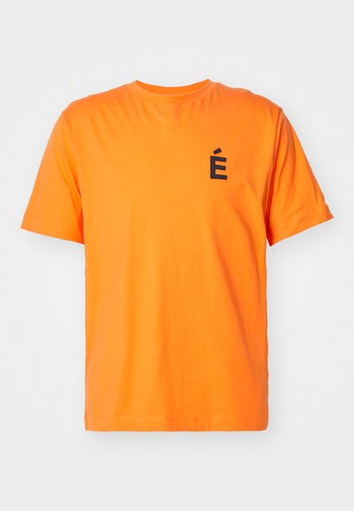 Orange cotton t-shirt featuring a crew neck, short sleeves, and a black embroidered letter "É" on the left chest. Plain texture.