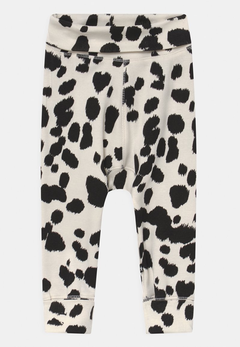 Leggings blancs pour tout-petits avec des taches de léopard noires irrégulières et une ceinture élastique.