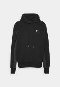 Svart huvtröja i mjukt material, med en känguruficka, dragsnöre i huvan och en neongrön Nike Air-logotyp på bröstet.