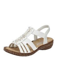 Sandale blanche avec une tige texturée ornée de perles décoratives, plusieurs brides et une semelle intérieure rembourrée. Semelle en caoutchouc avec un léger talon.