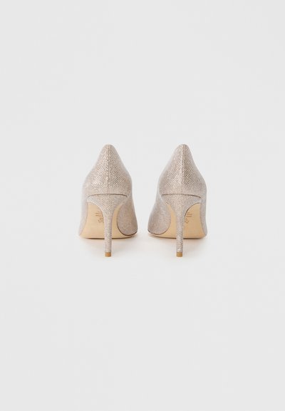 High-heeled shoes in light beige, featuring a textured shimmer finish, pointed toe, and slim stiletto heel. Smooth inner lining detail visible.