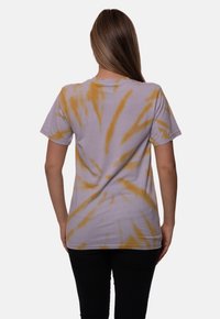 Purple and yellow tie-dye t-shirt, short sleeves, cotton fabric, relaxed fit, with swirling patterns and crew neck design.