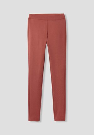 Leggings taille haute dans une couleur rouge atténuée, fabriqués dans un matériau lisse et extensible avec un design ajusté et sans motifs ni accents visibles.