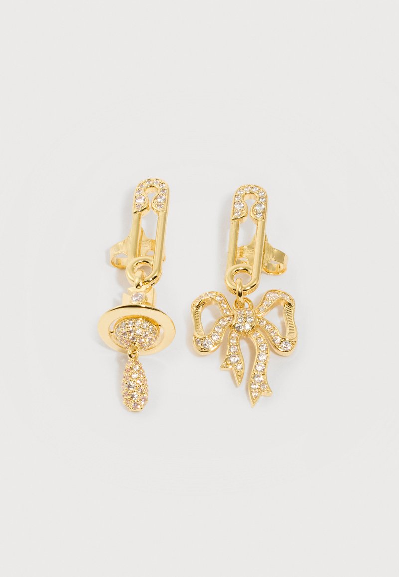 Gold-tone safety pin earrings with one adorned by a crystal-studded pacifier charm and the other by a crystal-studded bow charm.