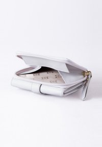 Light gray wallet made of textured leather with a zip closure, featuring a smooth interior and subtle embossed logo patterns.