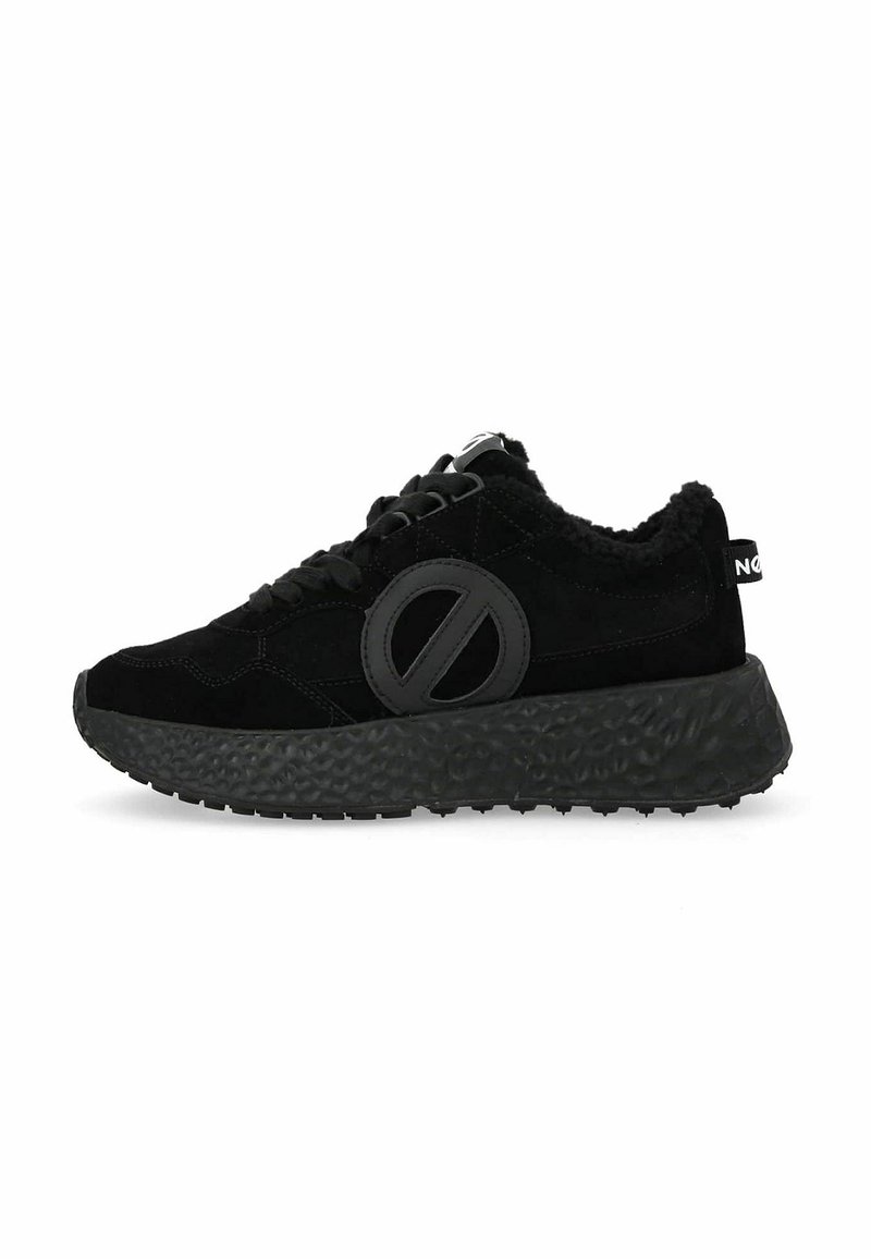 Black suede sneaker with a textured black sole, featuring a prominent circular logo on the side and fur lining around the collar.
