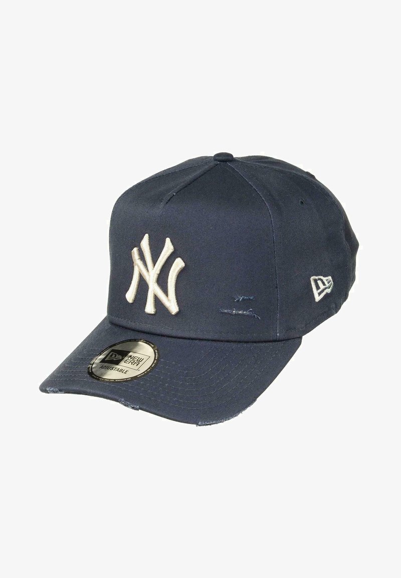 Navy blue baseball cap made of smooth fabric featuring an embroidered cream-colored New York Yankees logo and an adjustable strap.