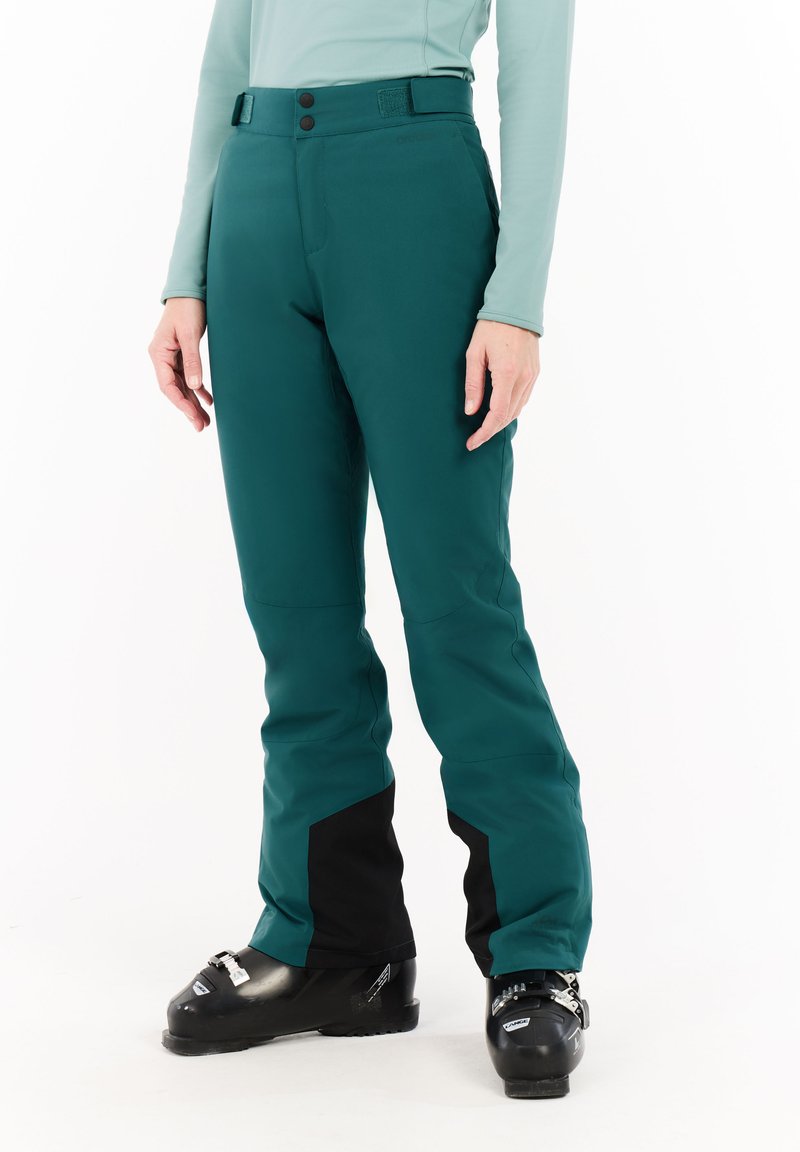Teal ski broek met zwarte accenten, gemaakt van een waterdicht materiaal. Ze hebben een slim fit, een verstelbare taille en versterkte onderbenen.