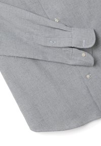 Chemise grise à carreaux avec un col boutonné, des poignets cintrés, et deux boutons sur le devant, fabriquée en tissu léger mélangé en coton.