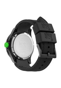 Black plastic watch with a textured strap, green crown, and stainless steel back. Features solar power and water resistance to 10 ATM.