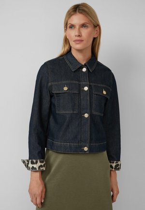 Giacca di denim scuro con bottoni dorati, due tasche sul petto e polsini a stampa leopardata. Il design corto presenta cuciture a contrasto e colletto classico.