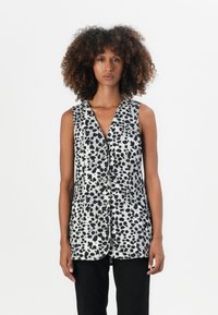 Gilet senza maniche in grigio e nero con un motivo astratto a pois, bottoni frontali e un design a V. Tessuto morbido, vestibilità regolare.