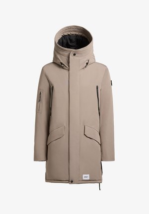 Beige parka-jack met een hoge kraag, ritszakken aan de zijkanten en een zwarte voering. Beschikt over een knoopsluiting en een gestructureerde stof.