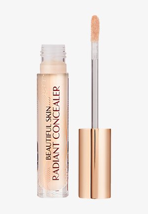 Radiant concealer in a transparent tube with floral design; light beige shade; includes a doe-foot applicator; gold accent cap.