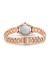 Roosakuldne metallkell, millel on roostevabast terasest rihm, ümar korpus ja sile finishing. Omab lukku ning graveeritud brändi detaile taga.