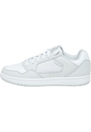 White athletic sneaker with perforated design, smooth leather and synthetic upper, round toe, lace-up closure, and rubber sole.