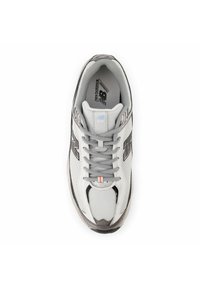 Gray and white running shoe with mesh upper, lace-up design, and a cushioned sole. Features black accents and a logo on the side.
