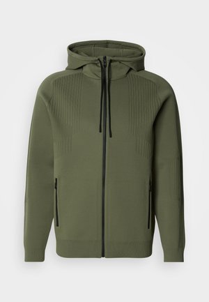 Olive green zip-up hoodie with a high collar, textured paneling on shoulders, black zipper, and side pockets. Smooth fabric, ribbed cuffs.
