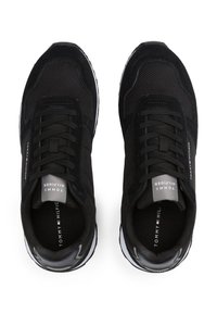 Svart atletiske sneakers med en blanding av mesh og semsket skinn, med et strømlinjeformet design, snøring og subtile merkeakenter.