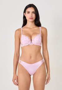 Light pink bra with floral embroidery and lace trim, featuring molded cups and adjustable straps. Matching pink thong with lace accents and bow.